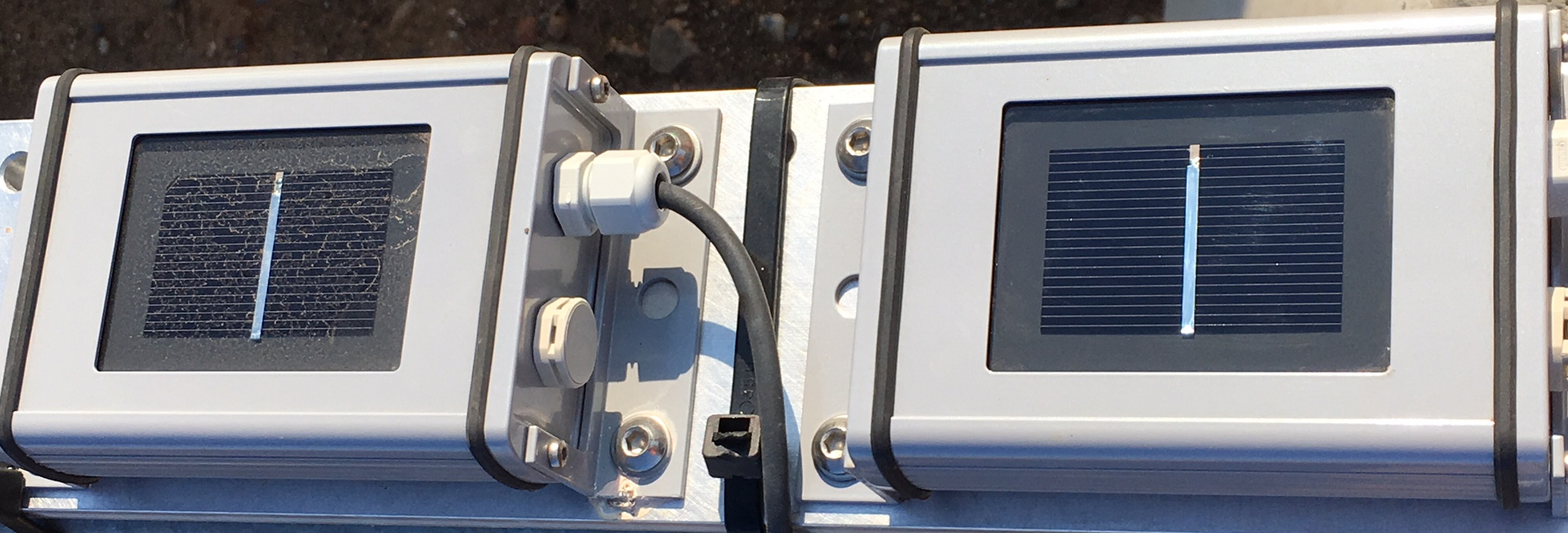 Photograph of soiling sensor showing the contrast between a dirty sensor at left and a clean sensor at right